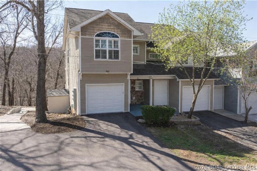Hard-to-find end-unit townhome in the heart of Lake Ozark with NO HOA dues, over 2,300 sq ft, a 1-car attached garage, and a location that puts you close to everything buyers love about Lake of the Ozarks. This 3 bedroom, 3 full bath, 1 half bath townhome offers a spacious multi-level floor plan with room to spread out, entertain, and enjoy easy lake-area living. Main level features the primary living room, kitchen, and dining area. The walkout lower level includes a second family room, wet bar, additional dining space, and flexible room for a game room, media room, or man cave. The backyard patio offers extra outdoor space for relaxing, a fire pit, or entertaining guests. End-unit privacy means only one shared wall, and the zero-scape landscaping means low-maintenance ownership with no mowing. Located near marinas, boat slip rentals, shopping, popular restaurants, bars, and the Bagnell Dam Strip. This property is perfect as a full-time home, weekend getaway, or investment in a highly desirable Lake Ozark area.