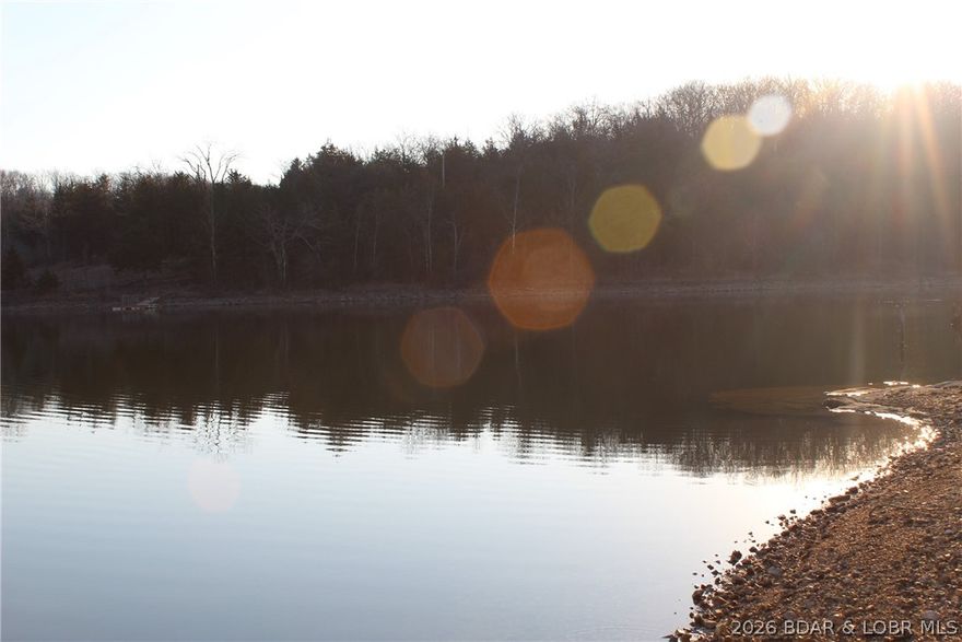 Gemini said
PRISTINE LAKEFRONT LOT ON PRIVATE POCAHONTAS LAKE! Lot 47 offers approximately 93 feet of shoreline on a peaceful, spring-fed lake. Because it is spring-fed, you get consistent water levels and NO winter drawdown, ensuring your dock and views are perfect year-round. This tiered lot provides a natural footprint for a walk-out cabin or a leveled camper pad with an incredible view across the water. Step down to your private gravel beach area, ideal for swimming, fishing, or launching a kayak right from your own property.

This lot is one half of our premier double-lot listing—buy just this piece for a private escape or ask about the adjacent lot to secure a full 182 feet of frontage! Ownership includes elite community amenities: a campground, playground, and community dock. For hunters, there is a dedicated resident-only hunting area. Practical features include on-site showers, a camper dumpsite, and even boat access to the Lake of the Ozarks for bigger water adventures. Fully stocked and ready for summer, this spring-fed lakefront is priced for a quick sale. Don't miss out on the best stable water in the area!