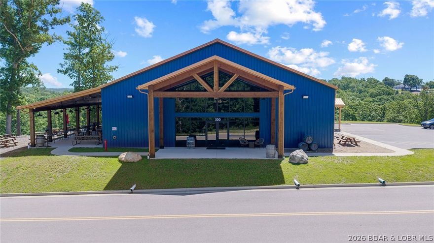 11 acres of endless opportunity in the heart of Lake of the Ozarks - Zoned C2! This stunning 12,000+ sq ft architectural showpiece is more than a winery or restaurant — it’s a destination property built for entertainment, hospitality, events, and future expansion. Located in a Tif District! This versatile property is perfect for a wedding venue, brewery/distillery, live music venue, boutique hospitality concept, mixed-use development, Year Around RV Resort or upscale investment opportunity.  Inside features locally sourced red oak from the property itself, vaulted spaces, exposed ductwork, multiple bar areas, a stocked commercial kitchen, conference/offices, and over 3,200 sq ft of patio space. The venue currently accommodates 200+ guests for public and private events. The flat, usable acreage behind the building creates incredible potential for outdoor weddings, cabins, short-term rentals, additional event space, or future development. Designed with expansion in mind, this is a rare opportunity to own a scalable destination property with unlimited upside at the Lake.