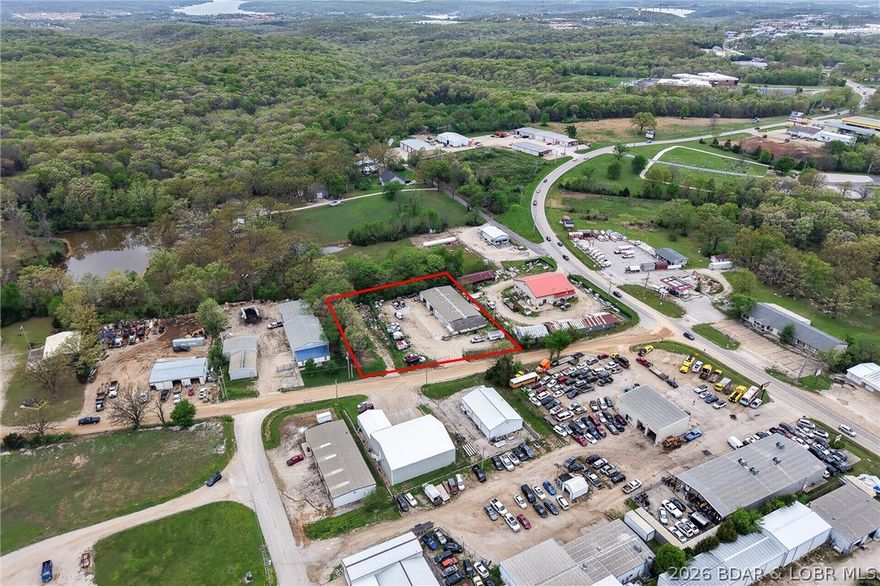 Absolutely fabulous location! Situated just off Highway 42, this versatile commercial property offers outstanding accessibility while still being within Osage Beach city limits. Set on a large, fenced lot, the approximately 5,600 sq ft building is designed to accommodate a wide range of uses. It features two large bays plus an additional heated bay, making it ideal for service, storage, or light industrial needs. Inside, you'll find a full kitchen area, 2.5 bathrooms, and seven separate office spaces which is perfect for operations that require both workspace and administrative areas. A spacious loft adds even more flexibility for storage or expansion. The property also offers ample parking and is zoned C-1, opening the door to numerous business opportunities. City water and sewer provide added convenience and reliability. Whether you're expanding, relocating, or investing, this property checks all the boxes for location, functionality, and potential.