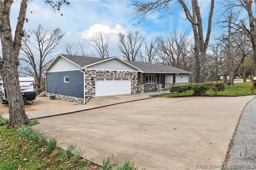 Camdenton Area, Off of Bridal Cave Rd: Prepare to be IMPRESSED w/ This Move-In-Ready (1.58 Acres) Home.  It is So Lovely after it’s Recent $150k-$175k Almost Total REMODEL Inside & Outside, (Mostly between 2024-25). This Home Offers 2970 SqFt, w/Oversized Attch’d 2 CarGarg, 4 Bed (1 non-conform’g)/3 Bath. The Home’s REMODEL includes: 2 Kitch’s (Custom Cabinets-Quartz Counters-Back Splashes-1 Big Island), 2 Liv’g Areas, 3Full Baths, Covered Back Patio & Upper Deck, Bedrms, Most Appliances, Staircase, Upgraded Cent’l Vac, Hm H20 Filtration, New Roof/Gutter, Stone/Vinyl Siding Exterior, Elect & Plumb’g, New Bonus Rm, Wood & Vinyl Floors, Front Porch, Sliding Doors+Some Windows & So Much More. It also Includes 35+Ft Full RV Pad w/Elect, H20, Sewer Hookups. Lrg Gentle Concrete Park’g Pad  (for 5-6 cars) w/ Full French Drain. On Cul-de-sac in a Quiet, Sleepy, Secluded Friendly Neighborhood. 570 Ft Rd Front. Large FENCED Back Yrd w/ 2 gates & Stg Bldg. Lovely Sunsets w/ Big trees to Block Warmer Afternoon Sun. Seasonal Lake view.  2 Min to Boat Slip Rental just Down the Hill from Home.  3-5 Minutes Easy Drive to Town. What Else Can you Ask for? Must see Detailed EXTRA FEATURE SHEET!