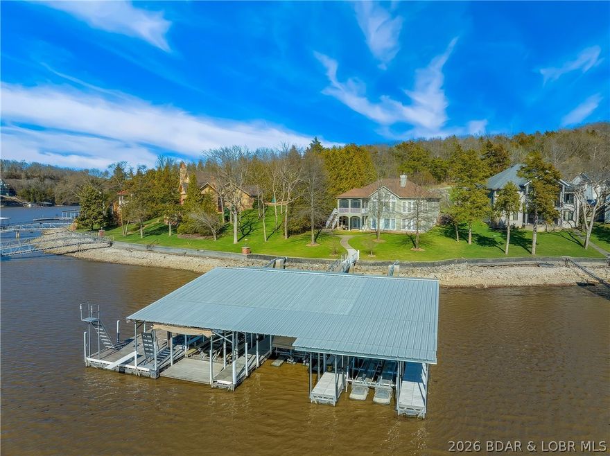 HOMES IN THIS AREA RARELY IT THE MARKET! Lakefront living at its best on the 11MM of the Big Niangua in the coveted Woobridge subdivision. This well-built 5-bed, 4.5-bath home offers 3,464 sq ft with a thoughtful layout, quality finishes, and outstanding lake access. The level lot from driveway to shoreline is a rare find, creating an incredibly usable setting with irrigation, mature landscaping, and easy access to the water. Inside you'll find spacious living areas including 2 living spaces, a well-appointed kitchen, and a screened deck overlooking the lake. Three of the 5 bedrooms feature ensuite baths, making the home ideal for hosting family and guests. Recent improvements include a newer roof, updated guttering and exterior paint, new HVAC in 2019, and updated flooring in the lower level. The custom 3,328 sq ft dock is a true highlight featuring 3 boat slips (14x48, 12x40, and 10x27) plus a 16x14 PWC slip accommodating 3 personal watercraft, dock locker, swim platform, and high dive—creating the complete lakefront experience. From the craftsmanship of the original build to the meticulous maintenance by the current owner, this property reflects attention to detail throughout.