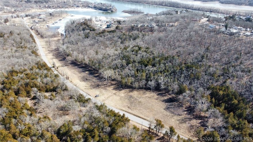 25± acres with private waterfront access to the Lake of the Ozarks, offering exceptional versatility and opportunity. This property features a desirable mix of cleared ground and timber and is located just off a paved road for easy access. Ideally situated only minutes from Warsaw, close to downtown Warsaw and Truman Lake. With strong potential for commercial, investment, development, or personal use, this tract offers numerous possibilities in a highly sought-after location.