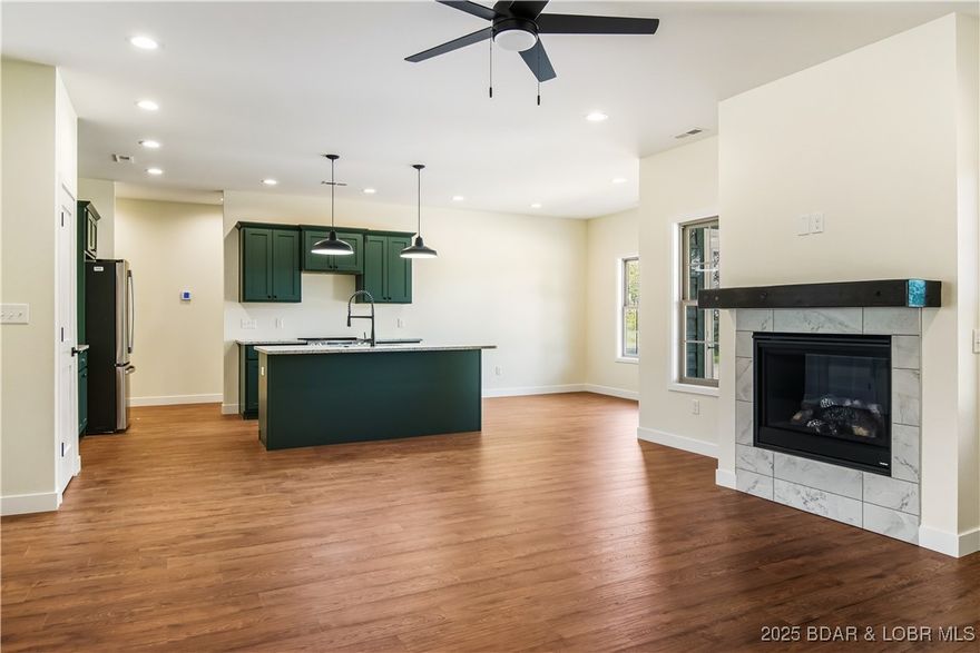 Modern New Construction in Lakeside at Cross Creek! Perfectly situated between Osage Beach & Camdenton, this quality-built ranch home is located in one of the Lake’s most attractive subdivisions. The scenic drive in on a freshly repaved road sets the tone for this beautiful community, surrounded by stylish, well-maintained homes. Directly across from the sparkling community pool and tennis courts, this property offers unbeatable convenience for everyday enjoyment. This is not your typical spec home—the builder used premium materials and thoughtful details throughout. You’ll appreciate the upgraded flooring, custom cabinetry, quartz countertops, stainless appliances, tiled showers, and elegant paint colors that give the home a warm, upscale feel. The smart layout provides one-level living with a 2-car attached garage and a slab foundation. This allows for a fantastic covered walk-out patio overlooking a flat backyard—ideal for relaxing, entertaining, or adding your personal touch. Whether you’re seeking a full-time residence or a low-maintenance lake retreat, this modern home delivers style, comfort, & craftsmanship in a prime location. Start enjoying the best of Lake living today!