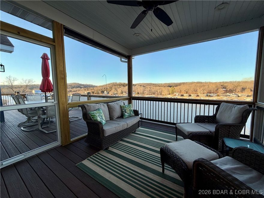 Stunning LAKE FRONT, MODERN, CRAFTSMAN located in a wide, quiet cove with DEEP water at Lake of the Ozarks! Amazing views with wrap around windows on the main level, four over-sized sliding doors. 9' ceilings on both levels and additional 10' trayed areas. Open concept kitchen, dining and living space & LVP throughout. CUSTOM CABINETRY in kitchen; beautiful GRANITE counter-tops & backsplash, large island and STAINLESS STEEL appliances. Primary bedroom with ensuite, WALK-IN SHOWER and custom closet on the main level. One-of-a-kind staircase of live-egde walnut connecting the main level to the lower. Two identical bathrooms with vintage 100+ year old ceramic sinks. Fantastic family room area in lower level with room to spread out! Three additional bedrooms to accommodate all your guests! VACATION RENTAL IS ALLOWED! 50 gallon water heater and fresh water supply manifold to boot! Enjoy lakeside views from open air decks or SCREENED IN AREA. 960 sqft of COMPOSITE decking, exterior stairs are composite too! Concrete dock with 12x30 slip, shed and swim platform for fun in the sun! Upper tier lot included, perfect for building an additional storage unit for all those lake toys! Owner Agent