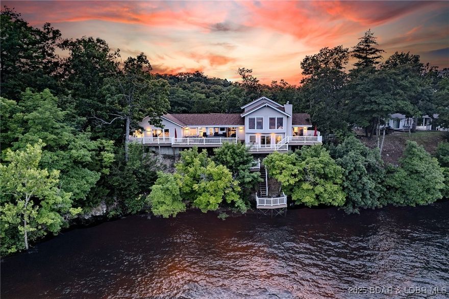 BREATH TAKING PANORAMIC VIEWS! This move-in ready 3-bedroom, 3-bathroom lakefront home offers 2,135 square feet of well-designed living space & a layout made for entertaining. Step inside to find a bright and open floor plan featuring a spacious dining area, open kitchen with stainless steel appliances, & the main living area captures every drop of daylight and delivers incredible views of the lake. Enjoy the comfort of a private en-suite in the master bedroom, complete with a jetted tub for relaxing soaks and a walk-in shower. The upper level bedroom offers a full bath and it's own private balcony for sipping morning coffee outdoors.
 An inviting entertainment room with a wet bar provides a stylish space for entertaining and can seamlessly transition into a second 
living area as needed. Outside, take in the stunning lakefront scenery while relaxing in the hot tub or from one of the 3 private decks. This home has a flat driveway and the 3-car garage offers plenty of space for an extra car or storage. This is a great opportunity to invest in a lakefront home to Air B&B or for your family. Conveniently situated on the 8mm close to restaurants and shopping. Don't wait on this one!