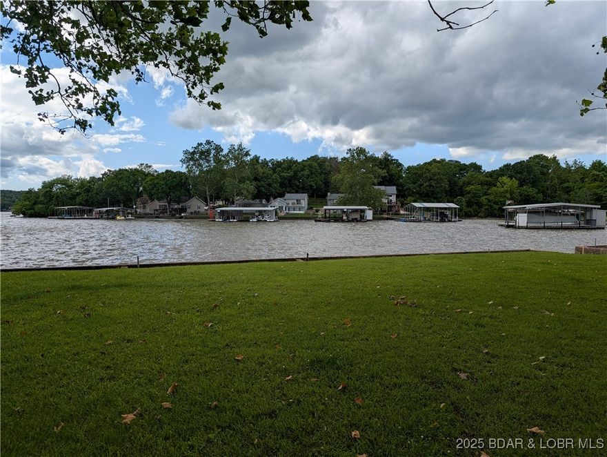 Beautiful land at the 49-mile marker at Lake of the Ozarks, MO. This is a second 9.01-acre plot in paradise at the Lake of the Ozarks, MO. This lot also has a dockable 77.95 ft beautiful FLAT waterfront lot (Utility Lot #2) included in the price....You could buy lot 1 and lot 2 and have 18 acres and 2 lakefront lots - 2 families sharing...Imagination and a chainsaw would go far in making this a very beautiful view of the lake and a place to put your new vacation home. The land is ready and waiting for the new imaginative owner who has plans. Step up and make it yours. No restrictions on the property - build a shouse or tiny home, a shop, or a beautiful conventional home. Electricity goes right by the front of the property, and there is a community well that is possibly for a fee to hook up to - all you need is a septic and your house plans- dream a little and make it big...ahhh fun days ahead.