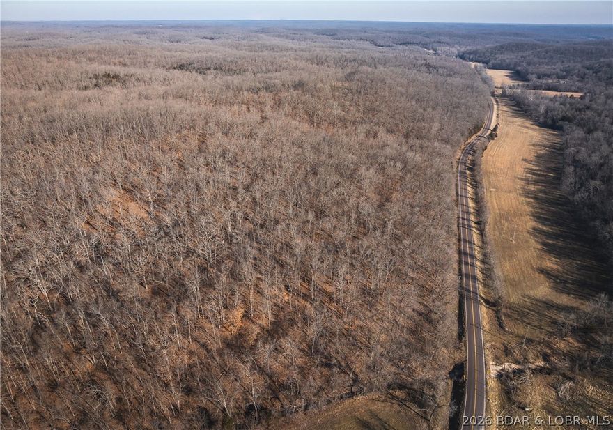 46.53 surveyed acres in the Gravois Mills / Versailles area. Properties like this are becoming hard to find, offering the perfect blend of recreation, convenience, and proven hunting success. This tract features north and south facing ridges, valleys, mature timber, thick bedding cover, established food plots, wet-weather creeks, and a trail system. The varied habitat creates excellent travel corridors and bedding areas, making this property extremely productive for hunting. It’s truly one of those places where you can step out of the truck and have a legitimate chance to harvest an animal the same day. The area is known for trophy whitetails and great spring turkey hunting. You will also enjoy mushroom hunting, artifact searching, hiking, and outdoor recreation, all just minutes from Lake of the Ozarks public boat ramps. The property also includes a fully finished container cabin with generator power, AC, propane heat, and a self-contained water system. Inside features a living area, kitchenette, bedroom, and bathroom, making it a comfortable base-camp for weekend getaways. With hardtop road frontage and a convenient location, this property offers both accessibility and privacy.