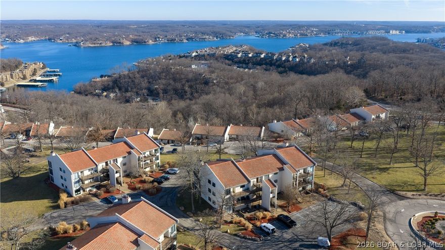 Welcome to effortless lake-area living!
  This wonderful 2-bedroom, 2-bath condo offers comfort, convenience, and charm—perfect for full-time living or a relaxing getaway. The primary bedroom complete with its own jacuzzi tub and separate shower. 
 With only 3 steps into the unit, accessibility is a breeze.  Step inside to an inviting open layout featuring tile floors throughout the  main living area and kitchen/dining, making upkeep simple and stylish. The kitchen shines with newer soft-close cabinets, granite countertops, and plenty of storage. A stackable washer and dryer add everyday ease.
  Enjoy a seasonal lake view from your cozy living space or unwind in the enclosed 3-seasons room, complete with a storm door and no steps leading out to a beautifully landscaped lawn—a rare and peaceful bonus!  Both bedrooms are comfortably sized with ample storage, and the unit is being sold furnished, making your move-in experience smooth and stress-free.
  If you’re looking for low-maintenance living with thoughtful updates, great outdoor access, and a touch of lake serenity—this is it! The unit can be used as an income producing unit on Short Term or Long Term rental programs.