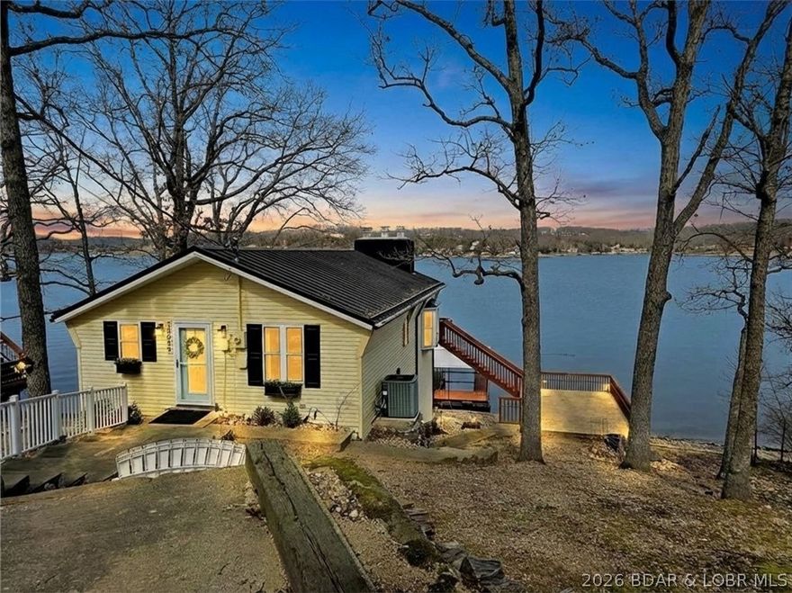 If breathtaking views are a must-have on your checklist for the perfect lake home, then you won't want to miss this gem. One of the first features that will capture your attention is the vaulted ceilings and large windows that flood the space with natural light while showcasing magnificent lake views. O Road is one of the most sought-after areas of the lake, this property offers a sense of privacy with 100 feet of lakefront on a generous 0.38 acres. Many updates have been made, including a custom kitchen, metal roof, new siding, windows, exterior doors, and flooring. Enjoy several entertaining spaces both indoors and outdoors, including two distinct living areas featuring natural stone fireplaces. The lower level fireplace is equipped with natural gas, ensuring warmth even during power outages. Step outside to find multiple tiers of open and covered decks, along with a fantastic concreted patio area on top of the boathouse. The boathouse and storage shed are perfect for storing lake toys and tools.  This lovely neighborhood boasts several full-time residents who look out for one another. City sewer eliminates any concerns about a septic system. Did I mention the breathtaking views?