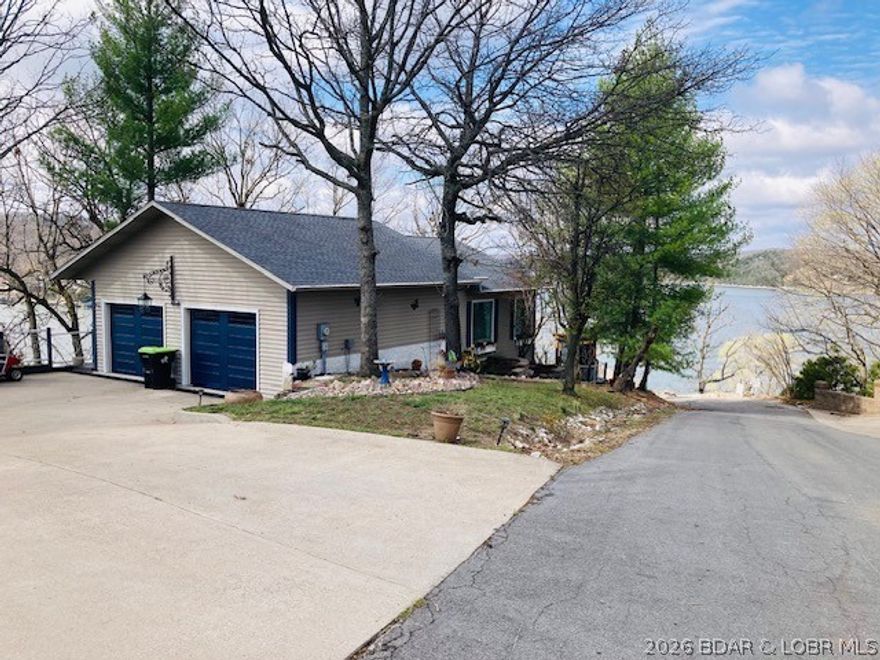 Let the Ohhs and Ahhhhs begin as you enter this exquisitely redone, beautiful lakeview/lake access home with a 180-degree view of Lake of the Ozarks, MO. There is a 10x24 slip that comes with the home and affords lake accessibility. Not one area of this home has gone untouched as it has been lovingly updated to upscale standards...There are many custom-built ins you won't see in many homes and turns of woodworking that are just wonderful. This home is set up for living with 3 outside decks and a cabana plus the sunroom from inside that is great in inclimate weather and affords the wonderful lake view...If you are wanting to have a view and a great place to call home - this is it...come take a look. Backyard is fenced also. HVAC are only 13 years old. See attached list of all updates done to the house