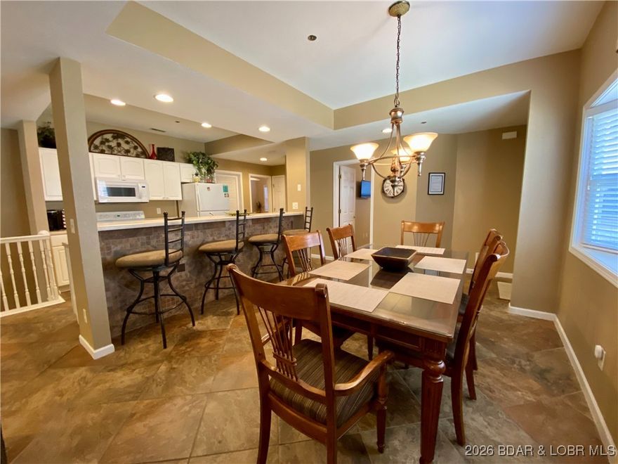 Boat days, sunset views, and space for everyone—this spacious two-story condo in gated Palisades Condominiums on Horseshoe Bend at the 14-mile marker of Lake of the Ozarks is made for lake memories. The main level features a private primary suite plus two additional bedrooms, each with its own full bath, giving family and guests room to relax. The open living and dining area flows into a bright kitchen overlooking the water—perfect for gathering after a full day on the lake. Downstairs offers a second primary suite and large living area for even more hosting space. Two lakefront decks provide front-row views, and the 14x40 boat slip puts you on the water in minutes. Sold fully furnished for an easy start to lake life, this low-maintenance retreat is ideal for full-time living, weekend escapes, or investment potential (if allowed). Enjoy three community pools, a clubhouse, and quick access to dining, golf, and waterfront hotspots. Strong location, generous layout, and true turnkey convenience—this one checks all the boxes.