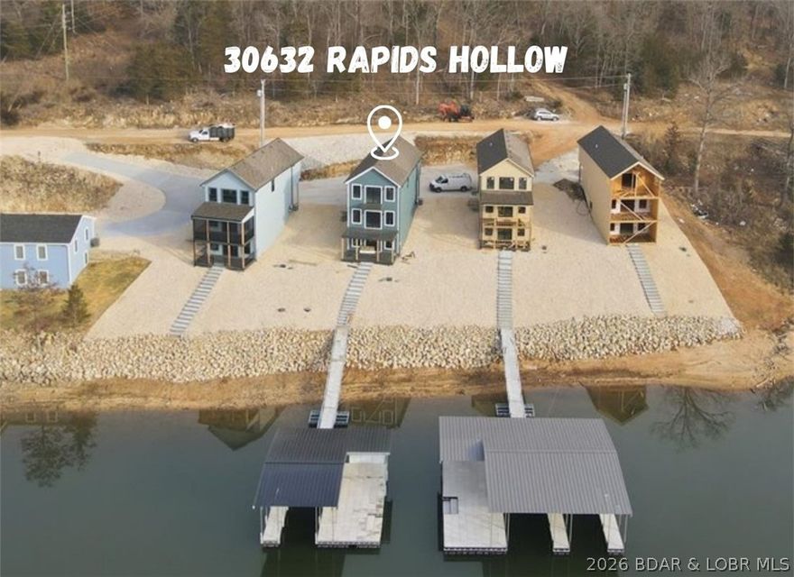 BRAND NEW LAKE HOME AND DOCK!!! Get ready for lake season with NEW! The perfect blend of modern design and lake living, and MOVE IN READY!!! Located in Proctor Cove on the 55 Mile Marker, this large cove is perfect for swimming, kayaking, paddleboarding, and the fishing is top notch! The home is designed for comfort and functionality with flat parking, two living areas, and plenty of outdoor space with composite decks on both the main and lower levels plus a balcony off the lakeside master ensuite! Inside, you’ll love the gorgeous kitchen featuring custom cabinets, quartz countertops, an island, sleek finishes, and stunning backsplash. Upstairs features two master suites while the finished lower level offers a third bedroom and a bathroom. Whether you’re enjoying the water, relaxing on the deck, or entertaining, this home was built to enjoy lake life. The yard is rocked for low maintenance and high speed fiber optic internet is available! One well boat dock features a slip 10x26 (can be opened up to 32 ft slip) with a huge swim platform and built in dock steps to the water and a 6x10 shed. Tons of space both in the shade or out in the sun plus there is room to add a slip!