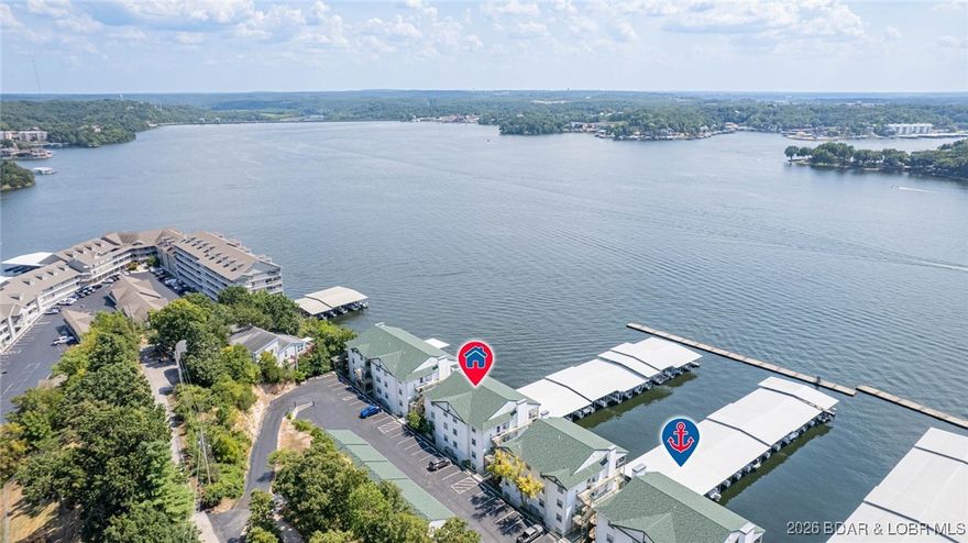 PACKAGE DEAL-CONDO WITH TWO ADJOINING GARAGES & BOAT SLIP INCLUDED! This 3BR/3BA end unit at Harbour Towne has endless lake and sunset views at the 2 mile marker at Lake of the Ozarks! It offers open concept living with over 1,500 sqft, 3 Bedrooms (2 ensuites) and 3 full baths. Updates include LG stainless appliances, Ruud hot water heater, electric fireplace, GE washer & dryer, A/C and LVP flooring throughout. Comes with 12x28 boat slip & dock locker-right in front of your condo. The expansive lake views from your screened in wrap-around patio are worth every penny! You will also fall in love with the amount of storage and the closet organizational systems throughout. Parking isn't an issue, as you get your very own assigned parking spot with plenty of overflow parking for guests as well! Plus, both garages are right outside the condo entrance and are the only adjoining garages at the complex. This makes an excellent choice for full-time, second home or investment opportunity with nightly rentals allowed! Close to Bagnell Dam Strip, local restaurants & shopping! Amenities include two heated swimming pools, club house, boat trailer parking, playground & tennis/pickleball court!