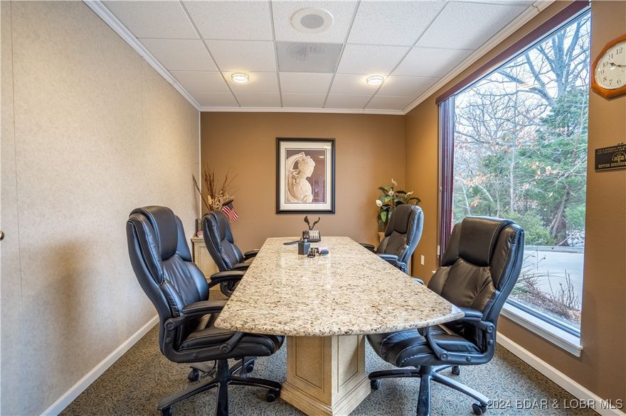 Great office space with high visibility off HWY 54 Expressway. Located close to the double diamond interchange of KK & HWY 54 Expressway, right off old HWY 54, this condo building has a lot of great owners. Easy access to all amenities in town, centrally located. 1100 SQFT with 3 offices, ADA accessible bathroom, kitchenette, conference room, file storage room (could be another office) and utility/storage room. $450 assessment per quarter covers water, sewer, trash, building maintenance & insurance, landscaping & parking lot maintenance. Office comes with two reserved parking spaces in front of the front door. Building is ADA accessible, and only one step to front door.  This is the cheapest office space you will find in Osage Beach for sale!