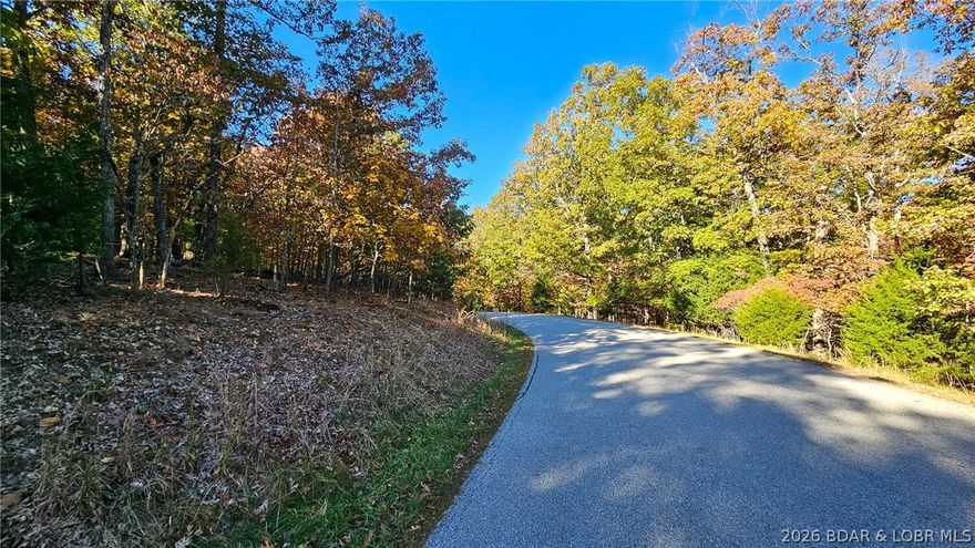 Discover the perfect setting for your dream home in the prestigious Porto Cima community! This serene 0.59-acre wooded lot, nestled on a peaceful cul-de-sac (Lot #785 Gleneagles Court), offers incredible privacy with mature trees and a gentle slope ideal for building. With convenient access from both Muirfield Drive and Gleneagle Court, your architectural vision has no limits. All essential water and sewer agreements are secured, and the HOA maintains a consistent neighborhood aesthetic with a 1,200 sq ft minimum home size. Beyond your private oasis, indulge in Porto Cima's exclusive amenities, including a lakefront exercise room, yacht club, and multiple swimming pools.