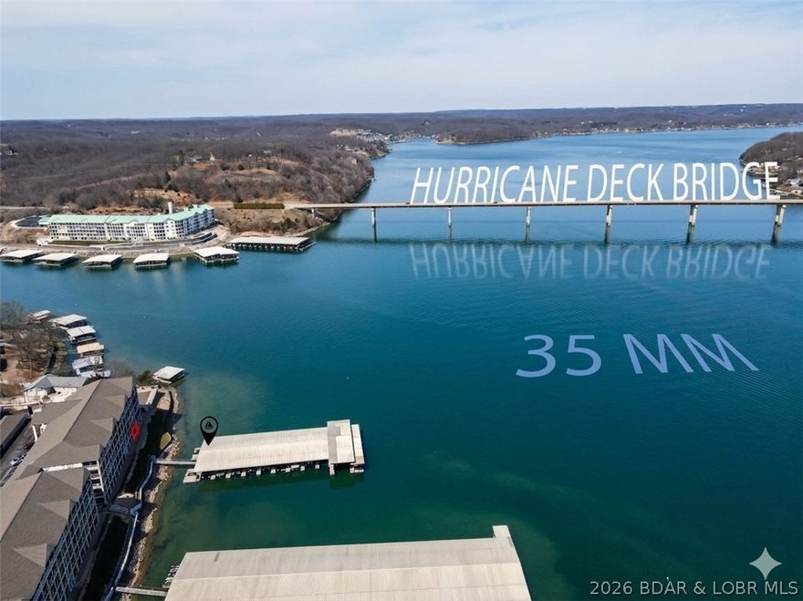 Host the ultimate lake weekend in this stunning ground-floor condo! Designed for entertaining, the massive open floor plan features a custom-opened kitchen with a breakfast bar and a dining area that comfortably seats 12+ so no one ever misses out on the fun. View of the main channel at the 35-mile marker, best enjoyed from your oversized screened-in patio. After a day on the water, relax by the fireplace or retreat to one of the spacious bedroom suites, each featuring its own private bath. With sleeping space for 8+. This is where your best memories begin.  Easy access to the dock with 12x32 slip w/lift & 2 PWC slips and access to the complex pool. Assigned parking spot too.