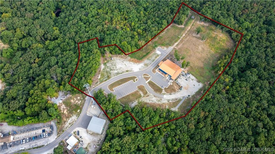Centrally located in Lake Ozarks, w/ future plans for 242 connection, stands one of the most solid buildings you'll ever see at the Lake! This architectural masterpiece winery/restaurant sits on over 11 acres and boasts 12,322 sqft of space inside & 3,240 sqft patio space. All the red oak inside has come from the property, making it that much more special/unique; not to mention the exposed duct work, black metals throughout, giving a industrial/farmhouse look. Currently the business hosts many public & private events (up to 205 people) and many local musicians. Other great uses to expand the business would be wedding venues, a brewery or a combination of it all; PLUS the additional land to expand to do other things. Back side of the building is FLAT which would make a great spot for weddings. Inside features vaulted dining hall, commercial bathrooms, 3 different bar areas, stocked kitchen & employee room. Upstairs includes a private conference room along w/ 4 office spaces & dining area outside that room. Lower level cellar features a fully operational wine production & solid concrete under the entire footprint of the property. Building is designed to be added onto if​​‌​​​​‌​‌​​​​‌​​‌​​​​‌‌ desired!