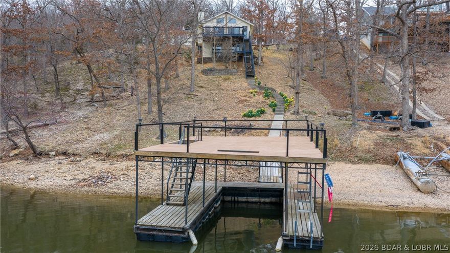 Escape to the quiet side of the lake without sacrificing a single modern comfort. This isn't just a lake house; it’s a fully reimagined sanctuary where every major detail has been handled for you. Situated at the very end of a protected cove, you enjoy 160 feet of private shoreline with 11-foot deep water, and a 10x22ft boat slip offering the perfect blend of calm swimming conditions and deep-water boat access. The interior boasts a complete top-to-bottom remodel featuring gleaming granite countertops, All new Interior Paint, all-new appliances, and a sophisticated mix of hardwood, custom tile, and newer carpet. Outside, the there is an oversized deck—completely replaced with treated lumber in the last 24 months—serves as your front-row seat to sunset views. With a brand-new HVAC (2025), a newer roof, and an updated septic system, you can spend your weekends on the water instead of on a to-do list. Just 10 minutes from town, this is the rare "hard to find" package that includes a 2-car detached garage and a concrete drive right to your front door. This would make a Full time home or Vacation Rental! If you want a larger dock it’s permitted to have up to 12x36 dock slip!