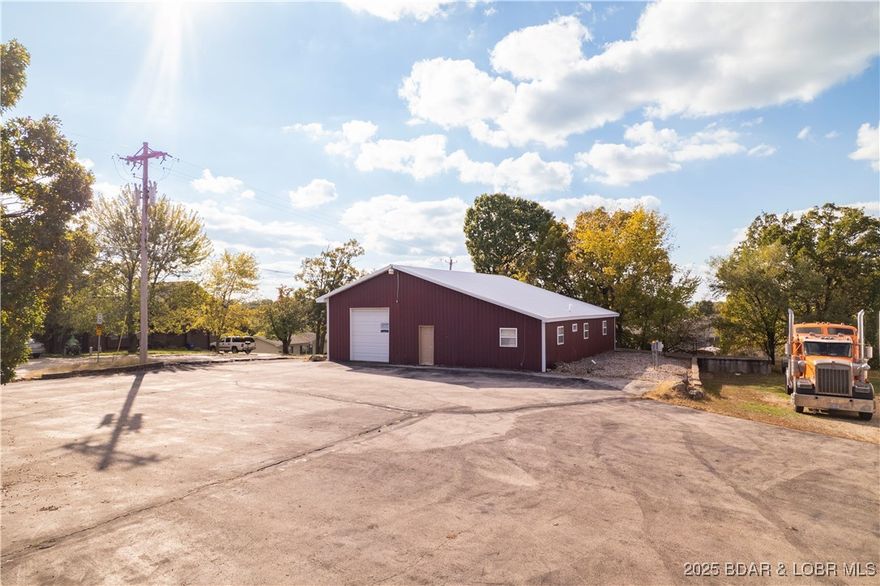 Here it is! PRIME corner-lot commercial opportunity in the true heart of Osage Beach — just seconds from Hwy 54 with unbeatable visibility and effortless access for customers, suppliers, and deliveries. Located in one of the fastest-growing commercial corridors at the Lake, this site offers exceptional exposure near major retail, restaurants, hotels, and key tourism traffic. This versatile I-2 Heavy Industrial-zoned property boasts 449’ +/- of road frontage on an approximately 1-acre lot, offering endless development potential. The 2,200 +/- sq. ft. warehouse includes an office, bathroom, 9x10 overhead door, and central heating & A/C. Plenty of parking plus a convenient loading ramp round out the functionality of this rare commercial find.  Whether you're expanding, relocating, or starting fresh — this is the kind of location that puts your business on the map in Osage Beach.