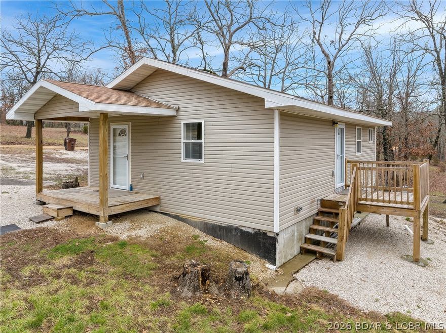 Charming Cabin Retreat Between Camdenton and Osage Beach! Are you ready to trade in the hassle and expense of renting for the tranquility of your very own cabin on a full acre? Nestled conveniently between the Camdenton and Osage Beach, this pristine cabin is not just a place to live; it’s a lifestyle choice. Embrace the freedom of homeownership in a serene environment that feels worlds away yet is just a stone's throw from the necessary conveniences. Spanning 720 sq ft,  the open-concept seamlessly integrates the living area, kitchen, and dining space. The bright and airy design floods the space with natural light, making it feel spacious and inviting. You will appreciate the practicality of the spacious combination bathroom and laundry. You will also appreciate having a like new storage shed to house your tools, hunting gear, etc. Whether you're escaping the hustle and bustle of apartment life or looking for a starter home that won’t break the bank, this property offers the perfect balance of comfort, privacy, and opportunity. Don’t miss your chance to make this dream cabin yours! Schedule a viewing today and start envisioning the life you’ll create in this charming space.