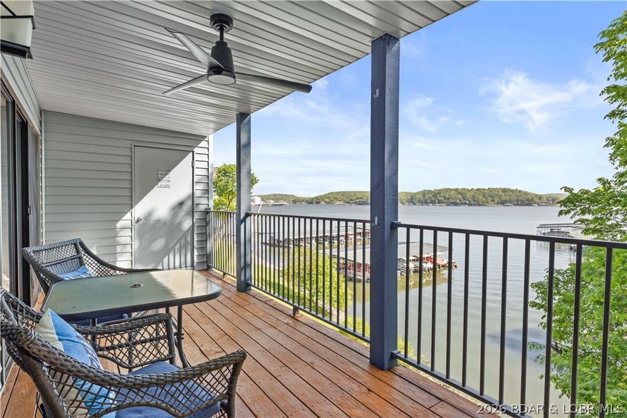Discover an extraordinary, fully furnished hidden gem boasting expansive views of the beautiful Lake of the Ozarks. Nestled within the well-maintained Wood Crest Condominiums, this pristine 2-bedroom, 2-bathroom unit spans 987 sq. ft., offering an open layout designed for seamless relaxation and entertaining. This is the ultimate turnkey package, complete with a 10'x24' boat slip and hoist included. Wake up in your Lakeside Master Suite and step into the vibrant lake lifestyle. Recent upgrades elevate the space, featuring new appliances, a contemporary stone electric fireplace, and a new deck ceiling. The interior is bathed in natural light, creating an inviting atmosphere that complements the scenic surroundings. Situated at the 3MM of the Main Channel near Horseshoe Bend Parkway, the location is unbeatable by land or water. The friendly complex features a responsive HOA with low monthly assessments, abundant parking, and premium amenities including a lakeside community pool, martini deck, and clubhouse. Don’t miss your chance to own this slice of paradise—experience it now via the fully interactive virtual tour!