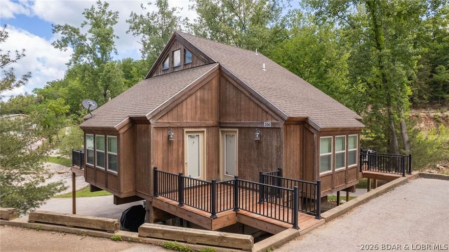 Rare opportunity for a high-performing lake-area retreat with income flexibility and prime location at the top of the Bagnell Dam Strip. This unique property offers beach views, a gentle driveway, and multiple lock-out configurations—perfect for personal use, rentals, or both. Designed to sleep up to 12, the home can function as four separate rental spaces. The main level features open living, dining, and kitchen areas plus two private lock-out primary suites. Upstairs, enjoy a spacious bunk room with full bath, while the lower level offers an additional suite that can be locked out or integrated. Community amenities include a sandy beach, pool, sand volleyball, and nearby boat slip leasing. Walk to popular restaurants and all the Strip’s events. Ideal for maximizing rental income or creating unforgettable lake memories.