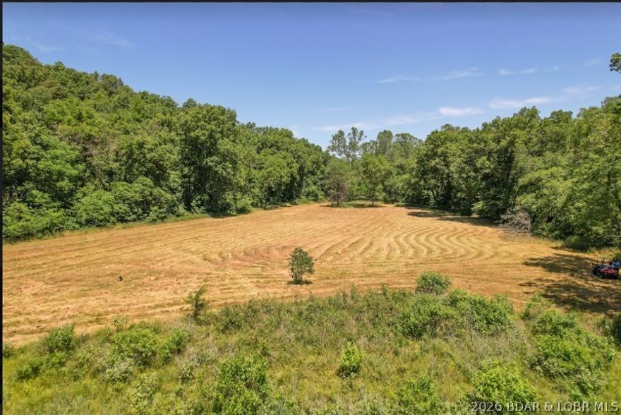 Offering an impressive 2,089' of gentle shoreline & 17.73 acres of beautifully diverse land. Held in the same family since 1952, this property carries over 74 years of history & presents a truly once-in-a-generation chance to own a large, private waterfront tract. A rare combination of acreage, shoreline, privacy, natural beauty—an opportunity that seldom becomes available at the Lake of the Ozarks. Outdoor enthusiasts will appreciate endless recreational opportunities, including fishing, kayaking, hunting,-exploring wide-open space. Property is rich with wildlife: deer, turkey, ducks. Eagles, making it a true haven for nature lovers. Previously operated as a cattle farm-enrolled in a forestry/crop protection program. Whether you envision a private estate, recr. getaway, hunting retreat, or legacy property, the possibilities here are truly endless. You will appreciate the endless recreational opportunities.  Shown by appointment after proof of funds. Seller must accompany all showings. Property is occupied-actively hunted— Do not access from Heather Rd or private driveway. Cameras/video security surveillance on property 24-7. Trustee for the trust is a licensed real estate agent.