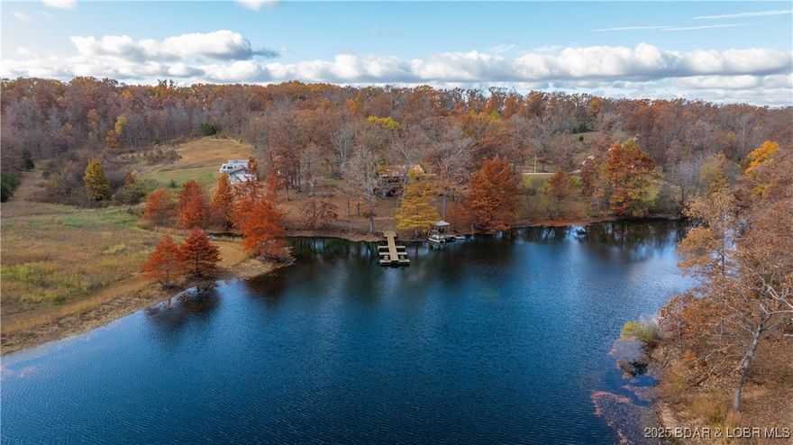 Peace, privacy, & postcard-worthy! 55-acre retreat with a stunning 4-acre, spring-fed pond—24 ft deep and stocked with bass, crappie, catfish, & hybrid bluegill! Enjoy morning coffee with the most amazing view, head out on it for afternoon fun, or end the day waterside. The land with itself is equally incredible with an orchard of 30+ fruit trees: apple, peach, cherry, & apricot, established trails through the timber, and loaded with deer and turkey! The driveway has an automatic gate at the road and then winds downs to the home featuring a wraparound deck, 3 bed, 2.5 bath and over 2,200 sqft of inviting space designed for comfort & connection. The spacious, updated kitchen has tons of cabinets new granite counters. Plus, the lower level adds a second living room and charming coffee bar. Move in ready with fresh paint inside and out, a new metal roof (June 2025), and 2 garages/shops, a carport, storage shed, chicken coop and more! Currently a successful Airbnb or would make an excellent place for full time living / personal getaway—this rare property offers the serenity of nature, the joy of recreation, and the feeling of home all in one unforgettable place!