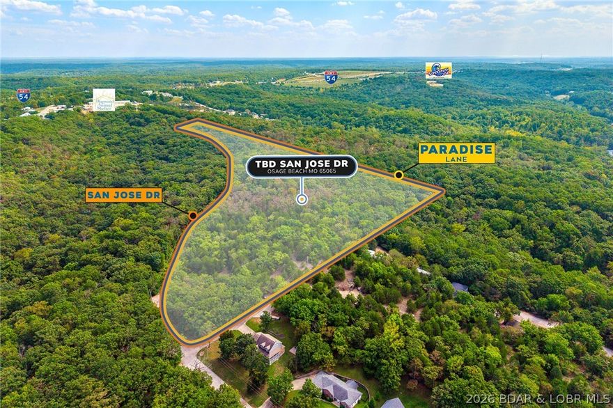 Discover nearly 20 acres (19.5±) in the heart of Osage Beach, perfectly positioned just off Hwy 54 near Runabout Drive. This versatile tract offers the ideal blend of accessibility and seclusion, making it well-suited for development, a private retreat, or recreational enjoyment. Enjoy close proximity to medical facilities, shopping, dining, and entertainment, along with convenient access to public lake entry and everything Lake of the Ozarks has to offer. The property provides a peaceful, private setting without sacrificing the benefits of a central location. With blacktop road frontage on both San Jose Drive and Paradise Lane, access is easy and infrastructure is already in place for future plans. Opportunities like this—offering size, location, and flexibility—are rare in Osage Beach.