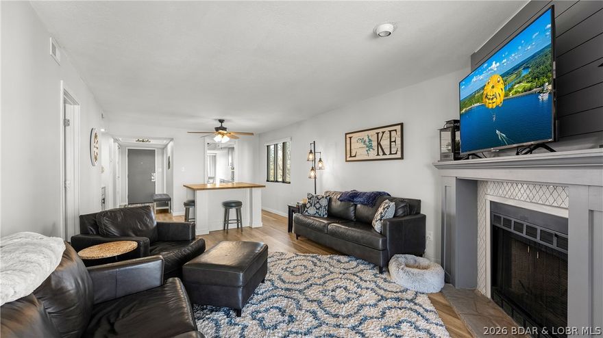 Just down the road from the renowned Hippopotamus Pool - the Lake’s largest swim-up bar! This beautifully updated condo puts you close to all the action while still offering comfort and space. Remodeled in 2020, the kitchen shines with stainless steel appliances, granite countertops, a massive fixed island perfect for entertaining, updated cabinet doors, and newer light fixtures. A wood-burning fireplace adds warmth and character, making it just as inviting in the cooler months. With 1,522 square feet, 2 bedrooms, and 2 bathrooms, this condo sports an impressive layout featuring two separate entertaining spaces, including a large sunroom complete with a movable bar, dart board, and sitting area. The oversized primary suite includes a walk-in closet, dual-sink vanity, tub, and separate shower. Enjoy the lake view, newer composite decking and railing on the building, and multiple pool options within Osage Vistas. Located in Four Seasons, you’re just minutes from dining, shopping, and everything Lake of the Ozarks has to offer. Offered mostly furnished and move-in ready, this is an ideal opportunity for full-time living, a lake retreat, or an addition to your rental portfolio!