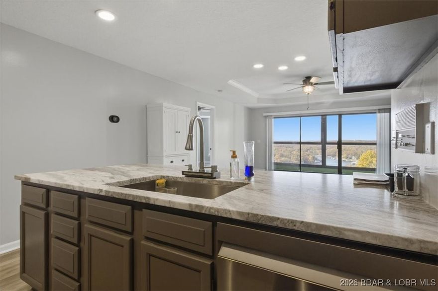 Enjoy the convenience of two reserved parking spaces exclusively assigned to this unit—no more searching for parking, even during peak season. Step outside to a spacious private outdoor area, perfect for entertaining, with the pool just a short distance away.  Inside, you’ll be welcomed by a bright sun porch, brand-new flooring throughout, and a full suite of newer appliances, including a washer and dryer. The kitchen and living spaces are enhanced with updated granite countertops, modern lighting, and stylish fixtures.
This home offers three spacious bedroom suites, each with its own private bathroom—ideal for guests seeking comfort and privacy. Take in breathtaking panoramic views of the lake and Powerline Cove, the perfect finishing touch to this exceptional property.  Experience resort-style living across 26 acres, with year-round amenities right at your doorstep. For added flexibility and income potential, the third bedroom can function as a lock-out unit with a separate entrance—perfect for rental opportunities. Plus, enjoy access to Four Seasons amenities.