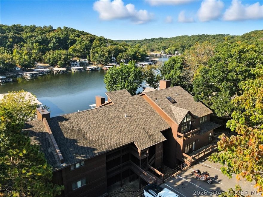 Discover lakefront living at its finest with this beautiful 2 bedroom (w/ bonus room that could be used as 3rd bedroom or office), 2 bath condo located in the highly sought-after Knolls Resort Condos. This end unit offers extra privacy & views of the 21 MM in Red Head's Cove. Thoughtfully updated throughout, the condo features a warm & inviting living area with a fireplace & stunning built-in shelving that adds character. Partially furnished, this condo is ready for your personal touch! A 10x30 boat slip and hoist is included, giving you convenient access to the lake. Hop in your boat & head to some of the lake’s most popular restaurants such as Redhead Lakeside Grill, Shorty Pants, Paradise, Backwater Jacks & Dog Days Bar & Grill, all just a short ride away. The Knolls is known for its extensive list of community amenities such as both indoor & outdoor swimming pools, tennis courts, a fitness center & plenty of gathering spaces for family & friends. This condo makes the perfect full-time residence, vacation home or short-term rental. Schedule your showing today!