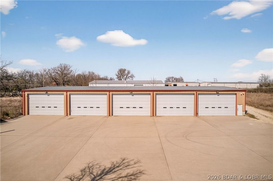 Position your business for success in this ultimate commercial facility in a great location! This impressive building is fully equipped to handle a wide range of operations, featuring oversized 14’ x 24’ doors w/electric openers—ideal for large equipment, vehicles, or high-clearance needs. The structure offers insulated walls w/inner steel lining, energy efficiency, and low maintenance. The spacious interior has a clear-span construction design w/no interior support columns, bathroom and is enhanced by newer fluorescent lighting, providing bright, consistent illumination throughout the workspace. Functionality is at the forefront with HVAC already in place for year-round comfort, along with a floor drain system extending through half of the building—perfect for wash bays, service work, or industrial use. Security is covered with camera systems both inside and outside, offering peace of mind. Outside,a substantial 70-foot concrete apron provides ample space for maneuvering, loading, and parking, making access easy for trucks, trailers, and heavy equipment. This is a rare opportunity to own a well-built, highly functional commercial property ready to elevate your business operations.