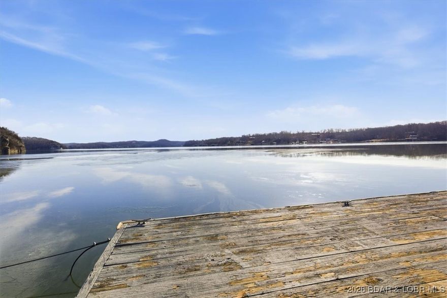 Get on the lake with this incredible 5.88-acre lakefront property offering over 300 feet of shoreline and stunning views. Enjoy a 54’ x 32’ dock with three boat wells, electric service, great water depth, and a storage shed ready to become the ultimate lakeside hangout. A 30’ x 40’ shop with concrete floors, three drive-in doors, and a roughed-in bathroom provides excellent flexibility—ideal for a shouse or future build support. Utilities include 50-amp service, wood stove venting, and AC accommodations. A 2019 Sportsman Toy Hauler currently sits on the prepared homesite (available separately), with a rocked, well-maintained drive leading to the shop. Build now, enjoy the RV, or both—the choice is yours.  Don’t miss this rare lakefront opportunity—schedule your showing and step out onto the dock to take in the view.