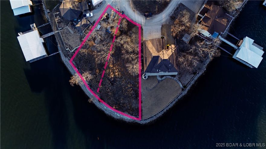 This rare double lakefront lot offers unbeatable panoramic views from its prime point location on a scenic bend. Enjoy the best of both worlds—big water views and the calm, protected setting of a cove for your private dock. With ample space to build your dream lake retreat, this property is a rare opportunity to own a one-of-a-kind homesite. Don't miss out—there aren't many lots like this left!