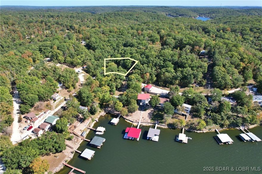 Lakeview Lot on Marina Lane – Perfect for Building or Camping!  Discover your own slice of Lake of the Ozarks paradise with this beautiful second-tier lot located at 27261 Marina Lane. Enjoy stunning seasonal lake views, mature shade trees, and the peaceful setting of lakeside living—all without the waterfront price.  Some excavating has already been done, making it easier to start your dream lake home or create the perfect camping getaway. Whether you're looking to build or just enjoy weekends away, this lot offers flexibility and potential.  Located just 10 miles from town, you'll love the convenience of nearby shopping, dining, and entertainment, while still enjoying quick access to the lake’s best amenities—boating, fishing, swimming, and camping are all just minutes away.  Don’t miss this opportunity to own a piece of the Ozarks. Your lake adventure starts here!