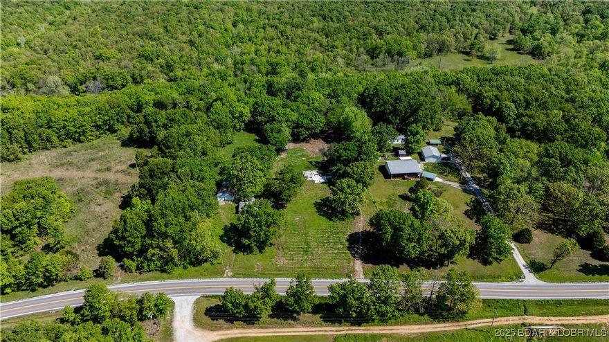 Looking for a slice of country? This 2.5-acre property offers endless possibilities with no restrictions—bring your RV, build a home, start a hobby farm, or just enjoy the peaceful surroundings. Located just 20 minutes from Warsaw, with Lake of the Ozarks access nearby, this is your gateway to both nature and convenience. The property includes a chicken coop, loafing shed, and an existing slab ready for your future plans. A well and septic system are already on site (condition unknown and not currently in working order), giving you a great head start on infrastructure. Whether you're looking for a weekend retreat or a permanent homesite, this is a rare find to create your vision.