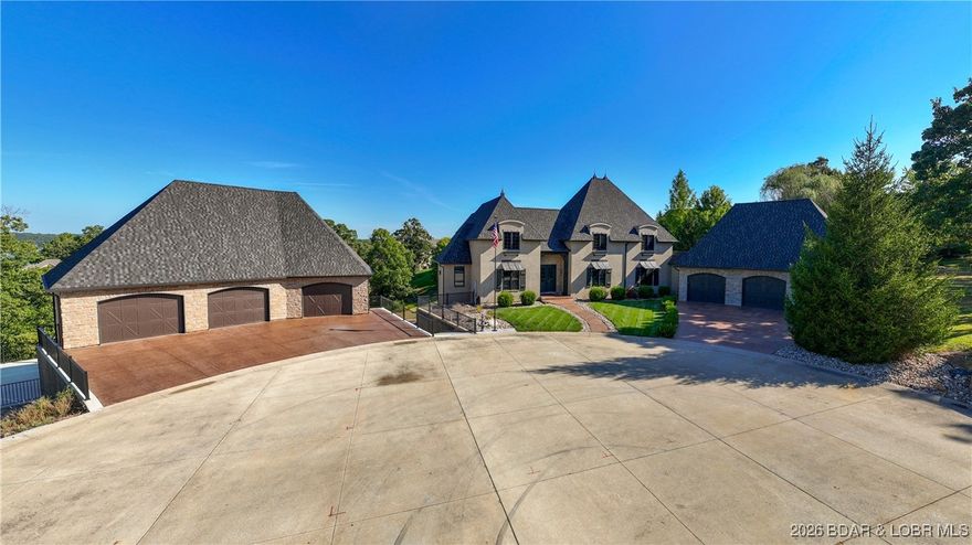 Welcome to a one-of-a-kind luxury estate in a gated Osage Beach community, occupying the feeling of its own private cul-de-sac. This entertainer's dream includes a 12x30 ft boat slip + PWC slip at the community dock, oversized 6+ car garages, a private pool, covered outdoor kitchen, private pickleball court, and half basketball court. The private pool house features its own kitchen, tons of entertainment space, an 8th bedroom currently used as a gym, sauna, and 2 bathrooms. The 7-bedroom main home offers 4 full & 2 half baths. High-end finishes include Travertine floors, wood beams, hardwoods, tall windows, vaulted ceilings, 8' doors, Alder millwork, and a stunning 3-story stairway. The expansive master suite boasts a fireplace, stone shower, soaking tub, dual sinks, and custom built-ins. The custom-designed kitchen features a high-end gas range, abundant handcrafted cabinetry, and a spacious walk-in pantry—perfectly blending style and function. The lower-level bar is a showstopper with stone seating and a cedar wine/bourbon locker. This home is loaded with custom; luxury details you must see to believe!
