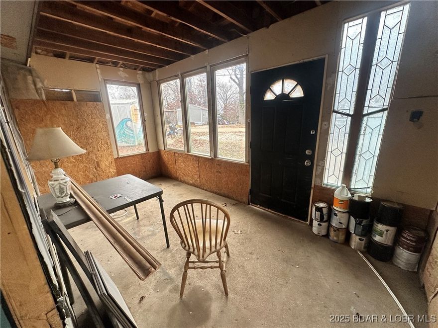 MOTIVATED SELLER! Are you looking for a project with real potential near Lake of the Ozarks? This Edwards property sits on just over 1/2 acre, and offers several solid structures and community lake access, making it a great option for a rental investment, weekend getaway, or future full-time home. The main residence is a 1970 single-wide trailer with a metal roof and a very nice addition that services as a great living space. The structure appears to be in good condition, but the interior will need updates, including plumbing, heating/cooling, flooring, and appliances. The property also includes a single-car detached garage, a small storage shed, a large, well built earth contact 2-car garage at the back of the property. This property includes a total of 6 lots in the Arrowhead Lakes Subdivision so is a spacious spot that needs a little love. If you’re looking for a fixer-upper with multiple outbuildings and room to make it your own, this one is worth a look. Bring your ideas, your tools, and your vision — there’s a lot of possibility here. Owner is selling AS-IS.