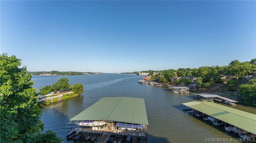 Prepare to be captivated by miles of main channel views from this stunning Lake of the Ozarks condo.  Whether you are hosting or unwinding after a day on the water, this condo is the ultimate lake lifestyle.  Enjoy legendary sunsets from your private deck, or a short trip to the nearby Bagnell Dam strip for the area's best dining and nightlife.   Brand new flooring and fresh paint in 2024, offering move in ready feel.  This condo is loaded with 14x36 boat slip, a one car garage with additional storage, and relaxing hot tub for owners to enjoy.