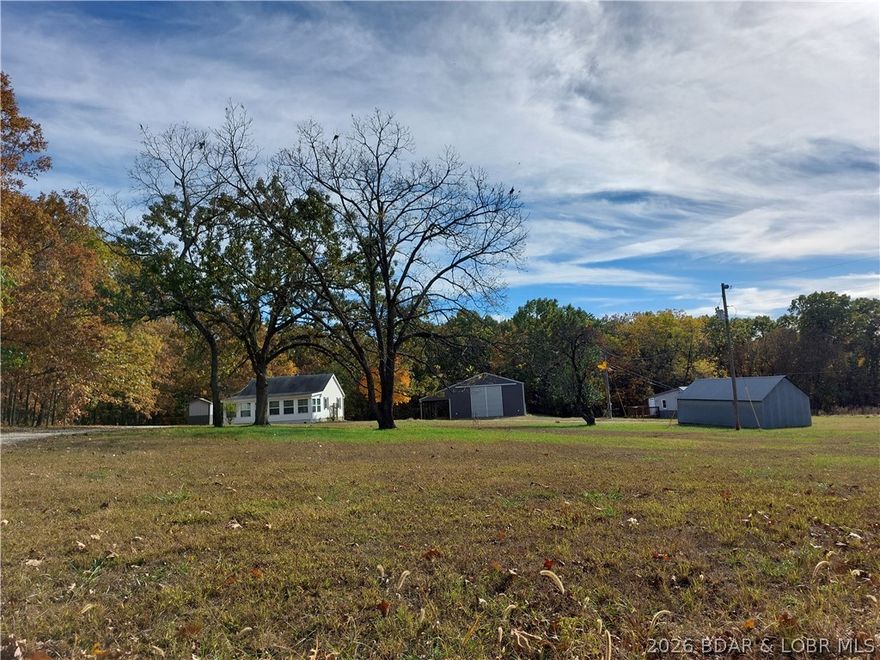 Almost 5 acres in the country is waiting to make this your new home! There is lots of room on this level, gentle acreage to build your dream home and use the existing homes for rentals or guests! NO zoning or building codes, NO HOA! No neighbors in sight! High speed fiber optic internet available for personal or business use! This 2 bedroom, 1 bath cabin has an enclosed sunroom for relaxing and watching the wildlife frequenting the area! A 2 bedroom, 1 bath ADU has a partial basement, kitchenette, and nice deck for entertaining or relaxing with your morning coffee.  A  30' X50' metal shop has electricity, insulated roof and features large sliding doors for access, and a 12' X 50' lean to for additional storage. There are also 2 outbuildings for more storage for machinery or equipment. Back area is a beautiful, level wooded area for enjoying nature or a nice location for building a new home to your specifications! Take a look today!