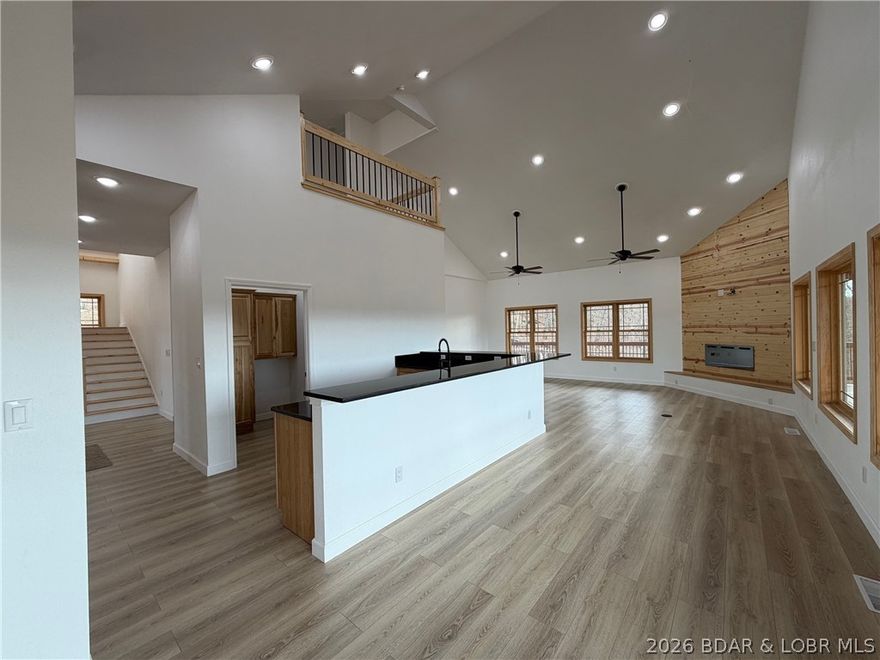 Hunting, Fishing and LOVING Everyday!! Wanting to get away from it all... Privacy and Seclusion is found at this Riverfront Property!! 9.7 Acres with 550+/- feet of Little Niangua Riverfront. PLUS this community adjoins that Fiery Fork Conservation Area & overlooks beautiful farmland...The Views are amazing and nature is just right out your door. Enjoy the beautiful setting from the oversized Wrap around deck. Home features Main Level Living with an open floorplan, Vaulted Ceilings in great room w/cozy fireplace, tons of windows, Walk in Pantry, Granite Countertops, Primary Suite on Main Level w/Stunning Custom Walk In Shower PLUS Jetted Tub & Double Vanity and laundry. Upper level features a Family Room that looks down into the main living room, 2 add'l bedrooms & bathroom. Lower Level Walk out basement features an add'l bedroom, bathroom, sitting area (perfect place for wetbar or keep laundry area) and HUGE covered patio. Unique Design w/ Poured Walkout Basement and Solid Concrete Piers Foundation... Built to last!  All of this & the Riverfront is amazing- with a level & cleared area that feels like your own park. Imagine taking a float trip & floating back to your own property!