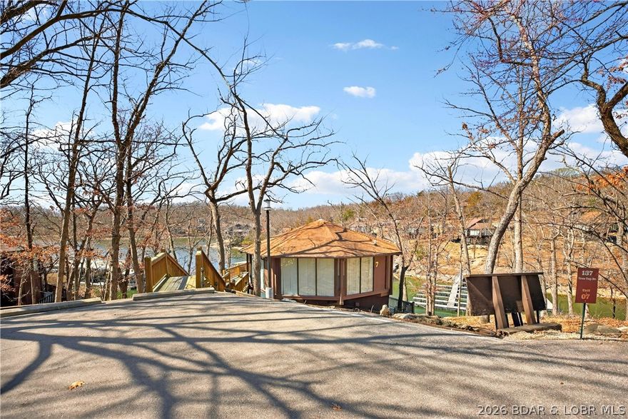 Enjoy treehouse-style living with true lakefront views and all the perks of lake life! This unique 2-bedroom, 3-bath stand-alone villa in Tree Top Village offers two spacious levels, each with its own private suite plus an additional full bath. Nestled among the trees right on the shoreline, the home features an open-concept layout, vaulted ceilings, and a private deck overlooking the lake — perfect for relaxing or entertaining. Residents enjoy resort-style amenities including indoor and outdoor pools, pickleball courts, lake access with boat slips, and full Four Seasons privileges. Whether you're looking for a weekend getaway, vacation rental investment, or full-time living, this lakefront villa offers the perfect blend of privacy, views, and resort-style convenience. Please note that this house will not be allowed to have a private dock, as the lake front is owned by the HOA. The plan is to bring more docks in for the community, but there is no timeline for that yet.