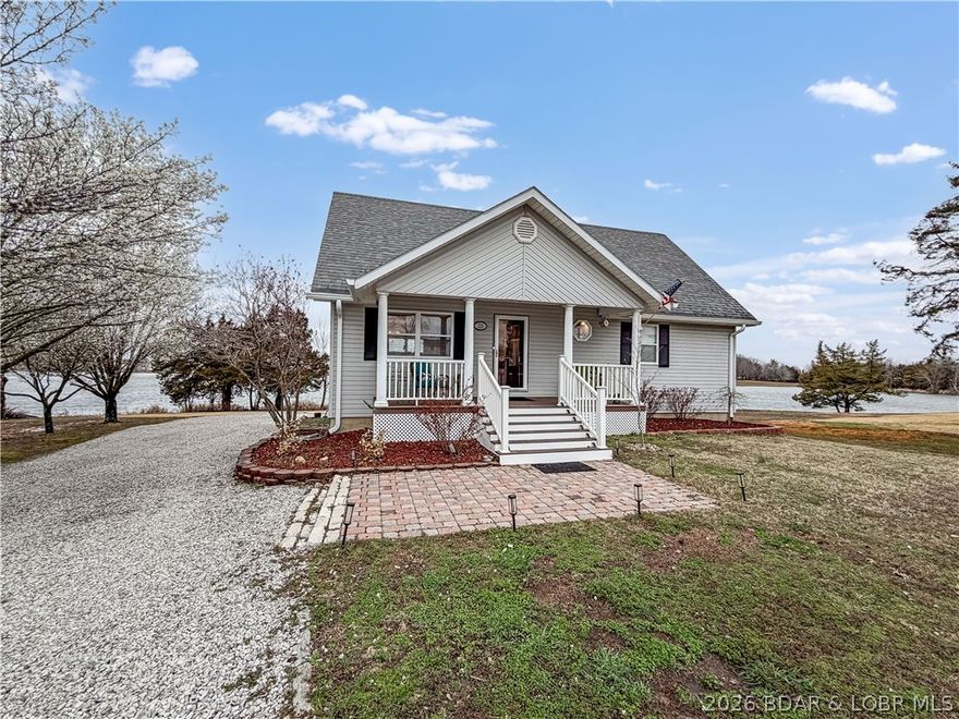 Beautifully maintained 2,259 sq ft (m/l) custom home on a prime Lincoln Lake waterfront lot. Enjoy stunning lake views from the covered deck or concrete patio with an easy, level walk to the water. Features include vinyl siding, Thermopane tilt-in windows, and a full finished walk-out basement perfect for entertaining. The spacious master suite offers a walk-in closet and washer/dryer connections. The kitchen boasts granite countertops and abundant cabinetry. Conveniently located near Truman Lake, Lake of the Ozarks, and just 20 minutes from Sedalia. Experience comfort, style, and lakeside serenity—schedule your private showing today!