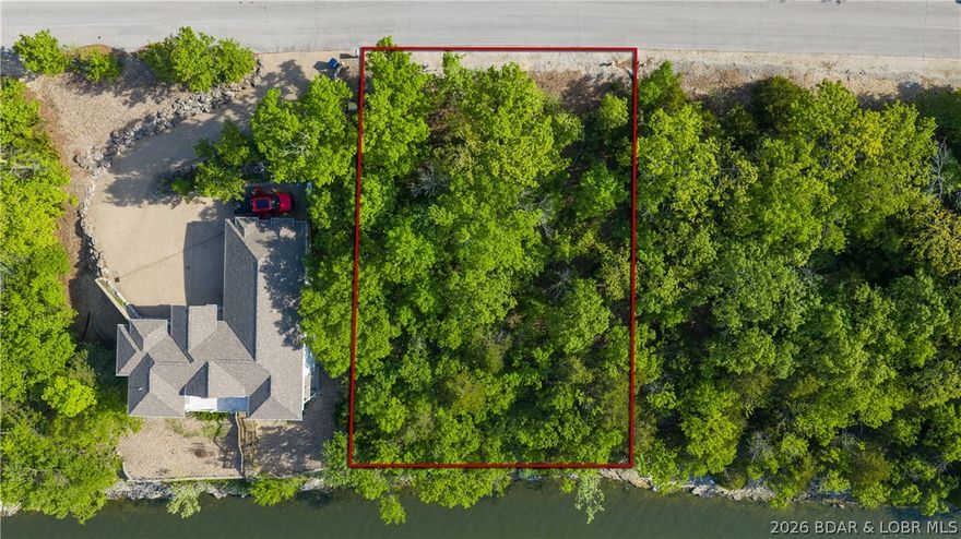Build where the views never get old. This south-facing waterfront lot in Beacon Pointe offers 100 feet of shoreline and wide, panoramic lake views. Positioned just minutes from Bagnell Dam and The Strip, you get quick access by both land and water while still enjoying the privacy and natural beauty this setting provides. With city water, central sewer, and electricity available, much of the groundwork is already in place to bring your lakefront vision to life. Whether you're planning a full-time residence or a weekend escape, this lot gives you the flexibility to design exactly what you want without compromise. Beacon Pointe is known for its well-maintained grounds and strong community feel, featuring a community pool, clubhouse, and playground for added enjoyment. Opportunities like this are limited, especially with this amount of waterfront and favorable orientation. Secure your spot and start building your place at the lake.