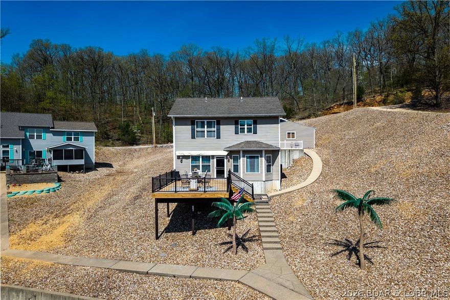 This is the kind of lake property everyone is looking for—turn-key, UPDATED, and ready for immediate enjoyment! This 4-bedroom, 2.5-bath lakefront home offers 1,761 sq ft on a .41-acre lot with extensive parking and a large detached garage/workshop built in 2019—perfect for all your lake gear. Enjoy an electric awning on the 16X24 deck on the hot summer days! 2nd tier lot also included.
Located in a quiet cove at the 3-mile marker, you’ll enjoy 88 feet of lake frontage, a swim platform, and easy access to the water with minimal steps. A 12x30 boat slip on the 5 slip community dock makes getting out on the water simple and convenient. 
Inside, the home features updated kitchen and bathrooms with stainless steel appliances, plus main-level laundry for added ease. Major updates include a newer HVAC (2026), water softener and hot water heater (2025), updated plumbing shutoffs, and a recently serviced and inspected septic system. Just minutes from Bagnell Dam, this fully furnished home is perfect as a full-time residence, weekend getaway or investment property—offering comfort, convenience, and the best of lake living. Nightly rentals allowed! Priced under recent appraisal.