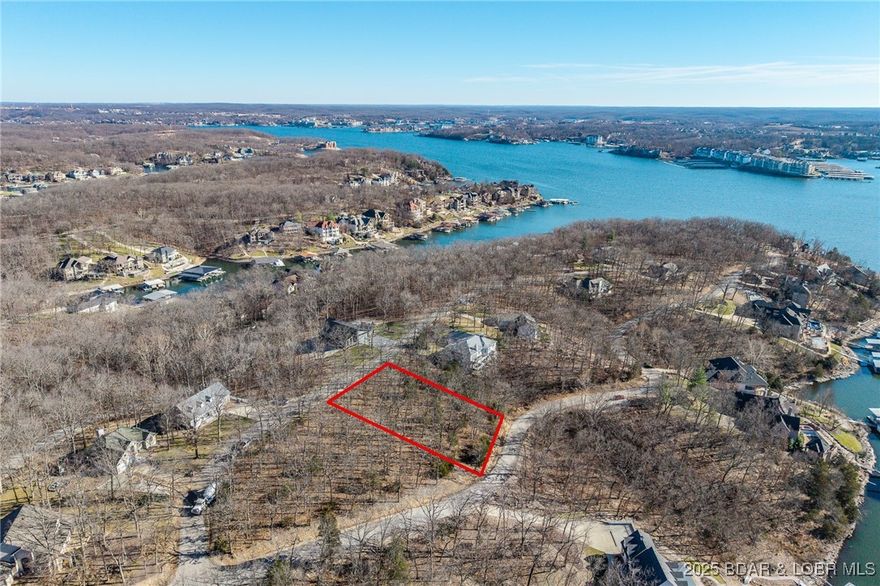 Enjoy the charm of ever-changing lake scenery with this Seasonal View lot at The Villages at Shawnee Bend. Partial lake views emerge throughout the year, offering a unique connection to the surrounding landscape while maintaining privacy and natural beauty. The community sets itself apart with a grand waterfall entrance and an impressive lineup of amenities, including a clubhouse, resort-style pool, championship tennis courts, and pickleball facilities. Parks, and playgrounds enhance the lake lifestyle, while paved streets and underground utilities provide modern convenience. This lot is ideal for a full-time residence or a relaxing weekend escape.