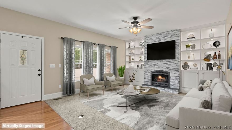 Welcome Home!! Let this blank canvas bring your design and decorating ideas to life! Imagine some beautiful spring landscaping. This stunning custom-built home located off of Horseshoe Bend at the first stop light-perfectly positioned to avoid the hassle of weekend or holiday traffic. This property sits on an oversized parcel made up of two lot's, offering tons of parking and plenty of space for entertaining family or friends. Step into and experience main-level living with thoughtful design throughout. The home showcases beautiful granite countertops and built in lighted cabinets that add both style and functionally. Relax in the spa-like bathroom featuring a walk in shower with dual waterfall heads, creating the ultimate retreat after a long day at the lake. It combines  everyday comfort with luxury touches, all while keeping you close to the best of Lake of the Ozarks!!