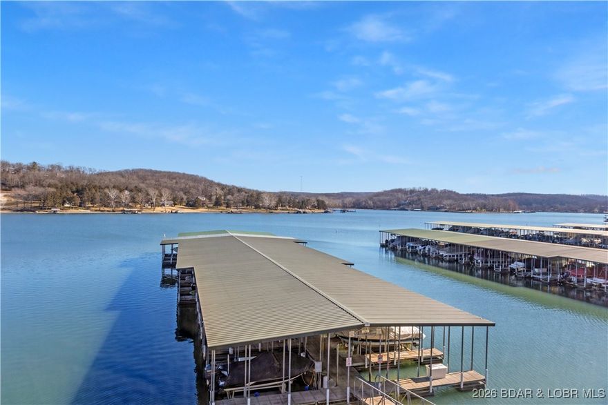 Enjoy lake living at its finest in this 3-bedroom, 2-bath condo in sought-after Cedar Glen Condos! Featuring beautiful views of the Big Niangua arm of Lake of the Ozarks. This light and bright condo showcases a custom, expanded kitchen thoughtfully bumped out for extra space, complete with quartz countertops, a coffee bar, pantry, soft-close drawers with sliders, and luxury vinyl plank flooring throughout. The open layout is perfect for entertaining or relaxing after a day on the water. Step outside and take advantage of the incredible amenities Cedar Glen offers, including two pools, playground, volleyball and basketball, horseshoes, fire pits, gazebo, boat ramp, dog-walking areas, and more.
This condo includes a 12x30 boat slip with a 8800lbs Hydro Hoist boat lift (w/2 remotes) and a 6ft dock locker, making Lake days effortless. Whether you’re looking for a full-time residence, weekend getaway, or investment opportunity, this condo delivers comfort, convenience, and the ultimate Lake of the Ozarks lifestyle.